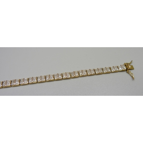 954 - A silver gilt tennis bracelet