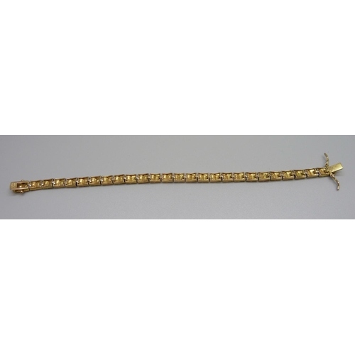 954 - A silver gilt tennis bracelet