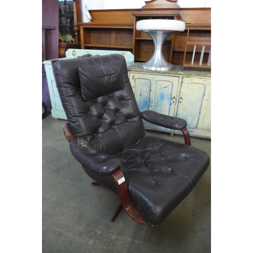 114 - A beech and brown leather armchair