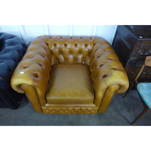 137 - A tan leather Chesterfield club chair