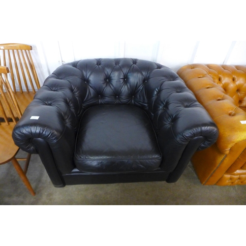 138 - A black leather Chesterfield club chair