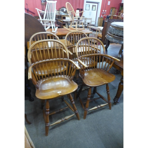 168 - A set of four Windsor style elm revolving bar stools