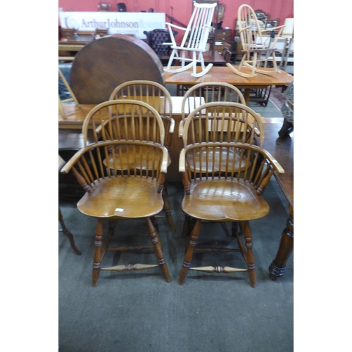 168 - A set of four Windsor style elm revolving bar stools