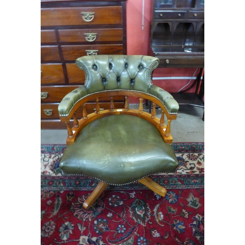 17 - A Hillcrest beech and green leather revolving desk chair