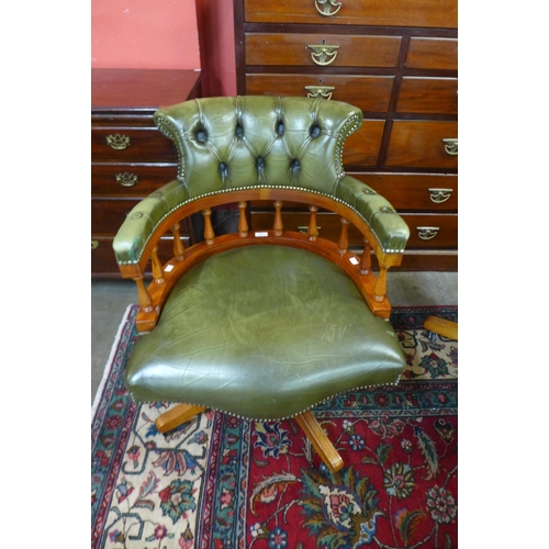 18 - A Hillcrest beech and green leather revolving desk chair