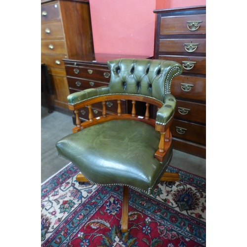 18 - A Hillcrest beech and green leather revolving desk chair