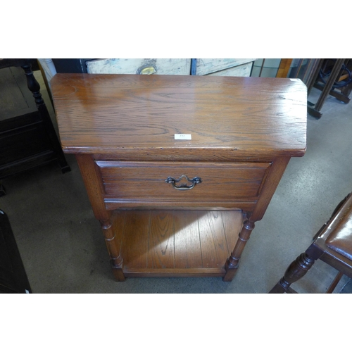 232 - An oak single drawer hall table