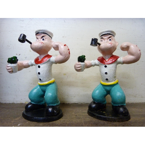 421 - A pair of cast iron Popeye figures