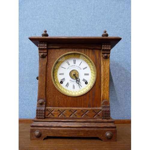 424 - An early 20th Century oak mantel clock, the dial signed Fattorini & Sons, Bradford