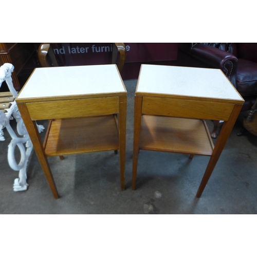 52 - A pair of teak and Formica topped lamp tables