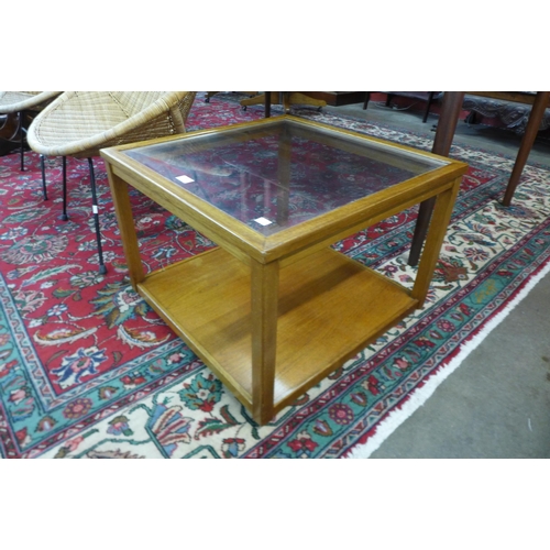 56 - A teak and glass topped square coffee table
