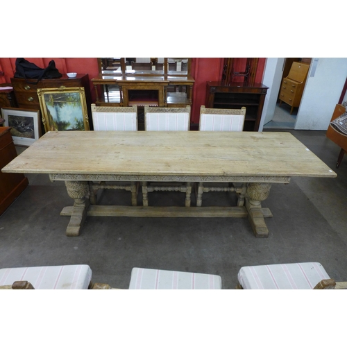 8 - A 17th Century style carved light oak refectory table and six chairs, table dimensions; 72cms h, 245... 