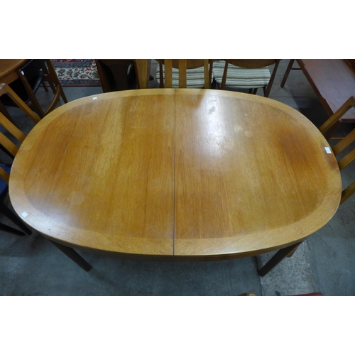 92 - A Nathan teak extending dining table and four chairs