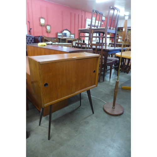 95 - A teak two door record cabinet on stand and a standard lamp
