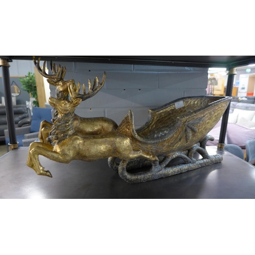 1381 - A gold ornamental sleigh with reindeer