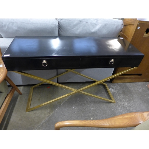 1400 - A black two drawer console table with gold legs