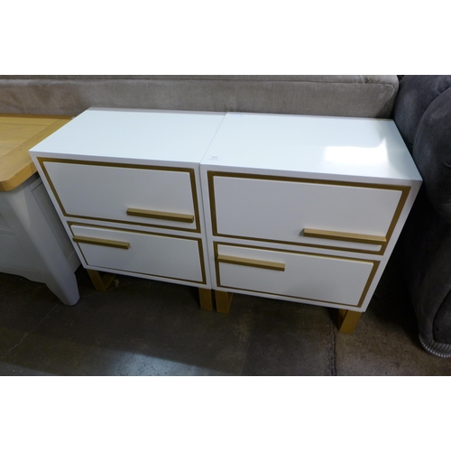 1413 - A pair of white bedside chests with gold legs