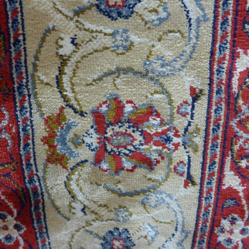 1486 - A full pile red ground Cashmere carpet with all over floral pattern, 240cm x 160cm