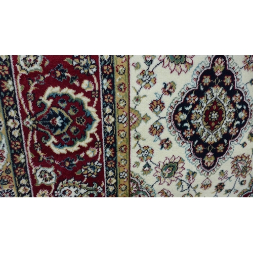 1490 - A red ground Royal Palace rug with all over medallion design, 135cm x 195cm