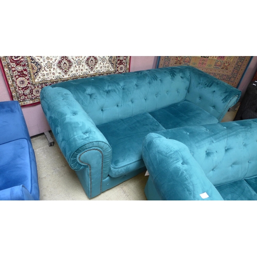 1491 - A pair of emerald velvet chesterfield sofas