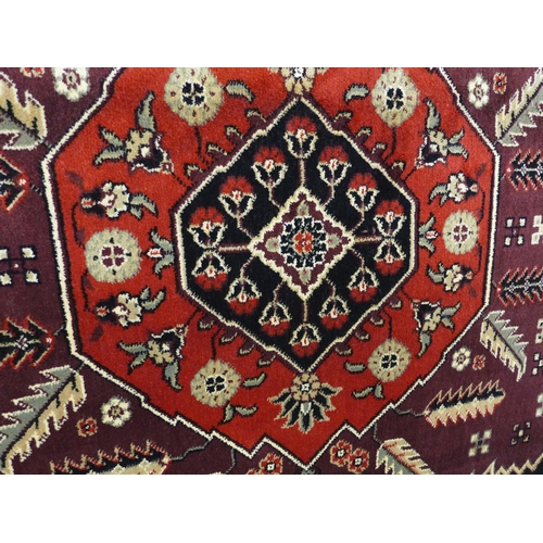 1496 - A red ground Cashmere carpet, with medallion design, 300cm x 200cm