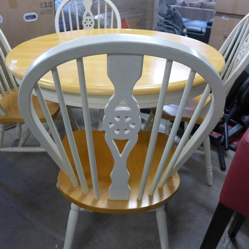 1562 - A beech and painted circular extending dining table and four chairs