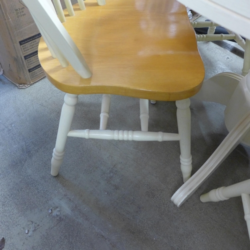 1562 - A beech and painted circular extending dining table and four chairs