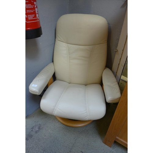 1578 - A Cream leather armchair and footrest