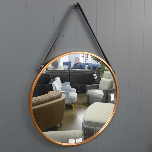 1347 - A copper rimmed hanging mirror with black strap