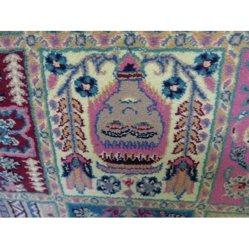 1495 - A teal ground fine woven rug with Persian panel design and inserts of pink