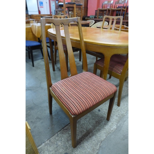 60 - A Nathan teak extending dining table and four chairs