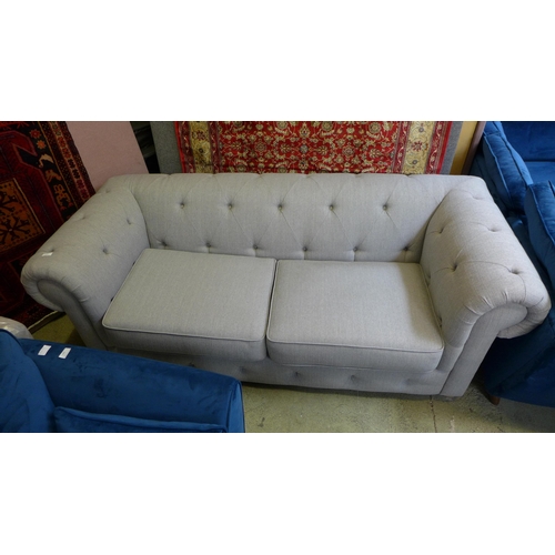 1492 - An Abbey grey upholstered chesterfield style three seater sofa - damaged feet