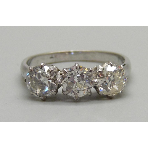 1019 - A platinum set 1930's three stone diamond ring, size O, 2.9g, diamonds circa 0.65 carat each, approx... 