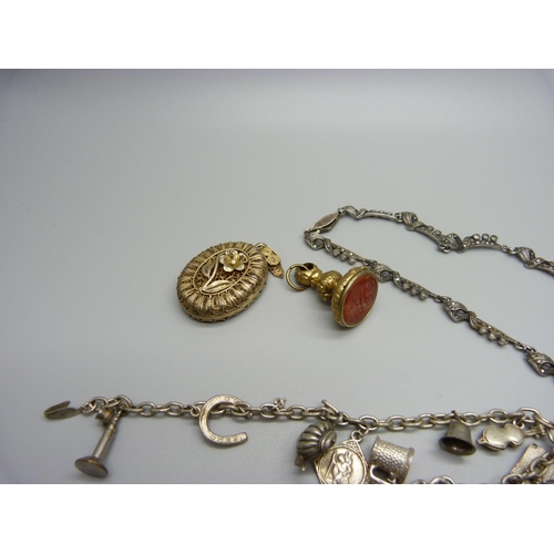 1069 - A silver and marcasite necklace, a filigree locket, loop a/f, a charm bracelet, etc.