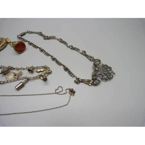 1069 - A silver and marcasite necklace, a filigree locket, loop a/f, a charm bracelet, etc.