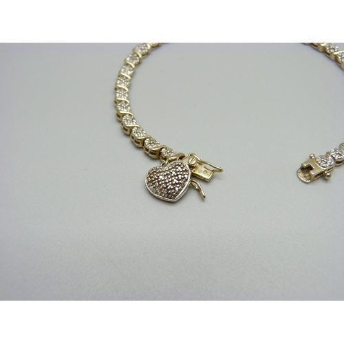 1081 - A silver gilt tennis bracelet with diamond accent