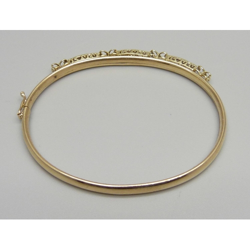 1110 - A 9ct gold and diamond set bangle, 6.8g