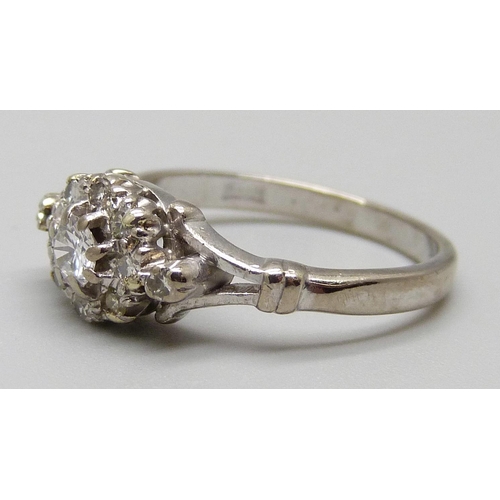 1122 - An 18ct white gold and diamond cluster ring, 3.7g, L