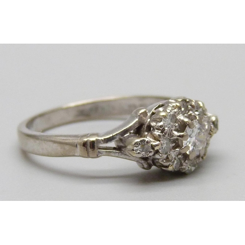 1122 - An 18ct white gold and diamond cluster ring, 3.7g, L