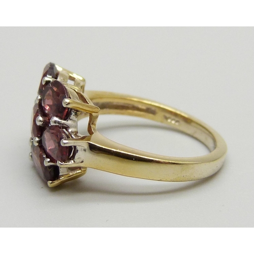 1128 - A silver gilt and almandine garnet cluster ring, L