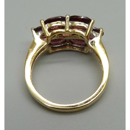 1128 - A silver gilt and almandine garnet cluster ring, L