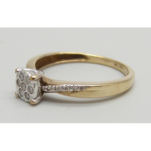 1134 - A 9ct gold, seven-stone diamond cluster ring with diamond shoulders, 1.6g, L