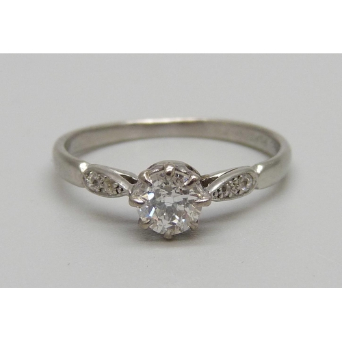 1141 - A platinum and diamond ring, main diamond approximately 0.55 carat weight, 3.1g, R