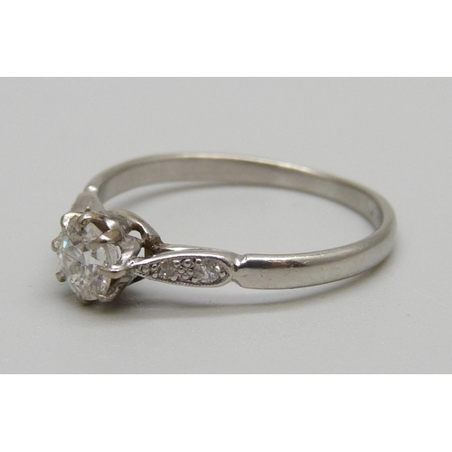 1141 - A platinum and diamond ring, main diamond approximately 0.55 carat weight, 3.1g, R