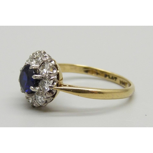 1145 - An 18ct gold, platinum set sapphire and diamond cluster ring, 2.6g, L, in old Bakelite box