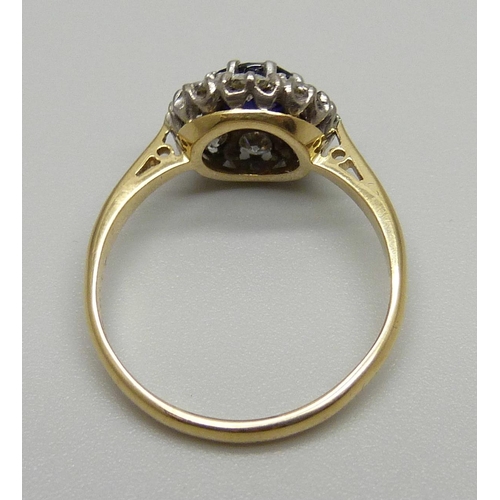 1145 - An 18ct gold, platinum set sapphire and diamond cluster ring, 2.6g, L, in old Bakelite box