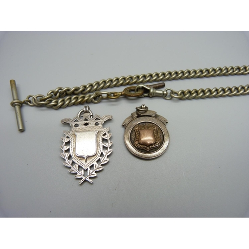 1173 - A metal Albert chain and two silver fobs