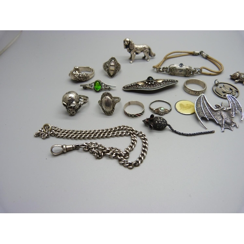 1199 - A silver skull ring, other rings, a hallmarked silver dog figure, 25g, a silver bat brooch, a silver... 