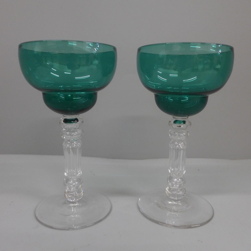 634 - A pair of circa 1850 green pan topped bowl wine glasses with cut stems