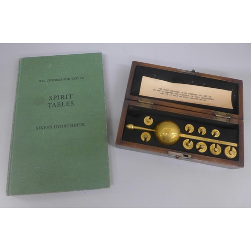 637 - A Sikes hydrometer, boxed, with book